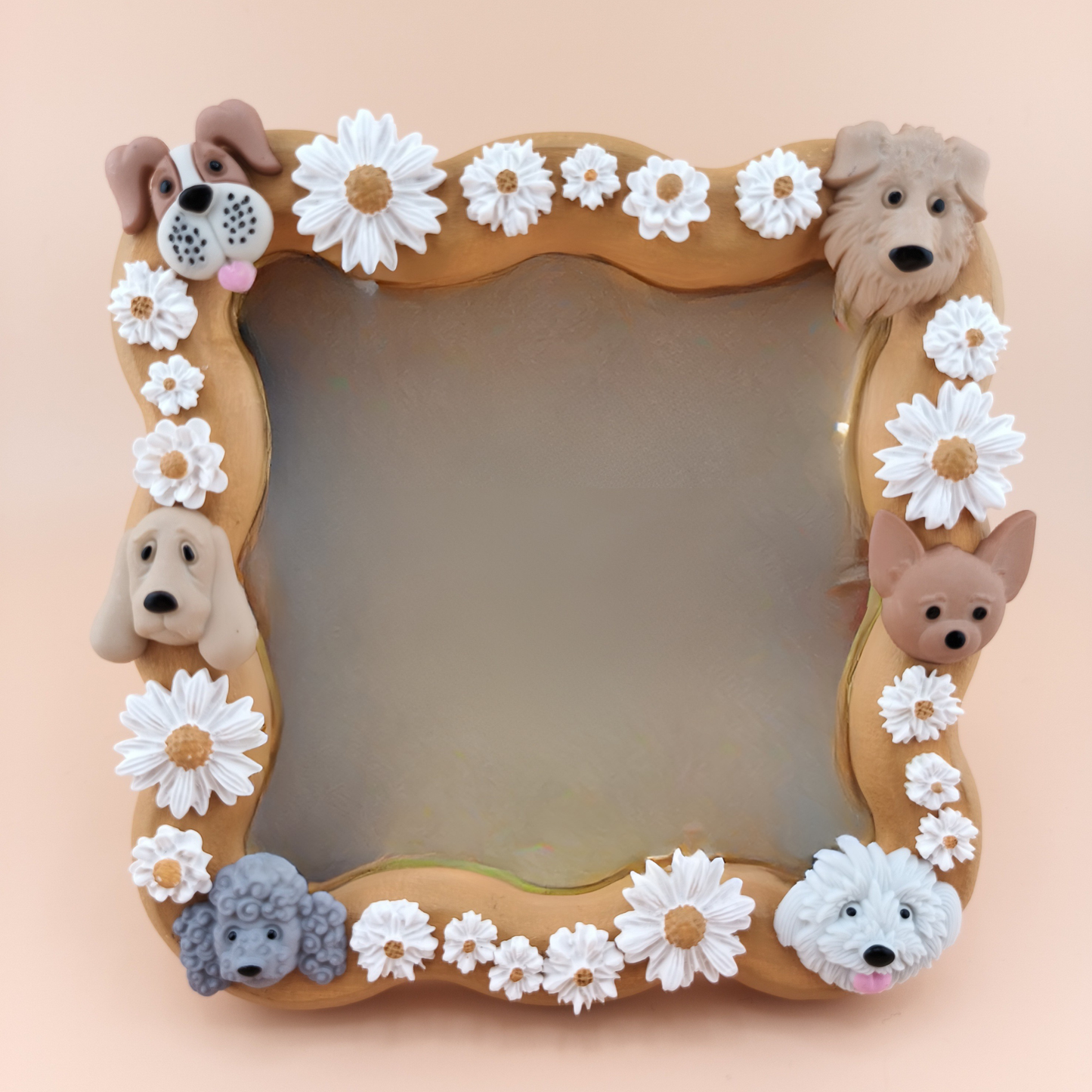 Decorative mirror with dog faces and flowers on a beige background