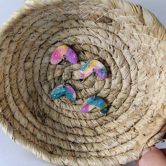 Colorful glittery earrings on a woven basket