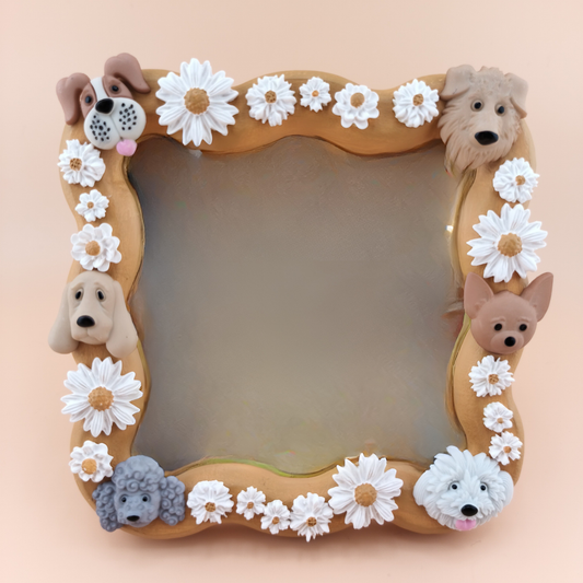 Decorative mirror with dog faces and flowers on a beige background