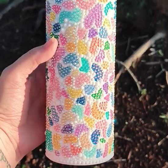 video featuring a multi colored terrazzo bedazzled tumbler, turning in a hand