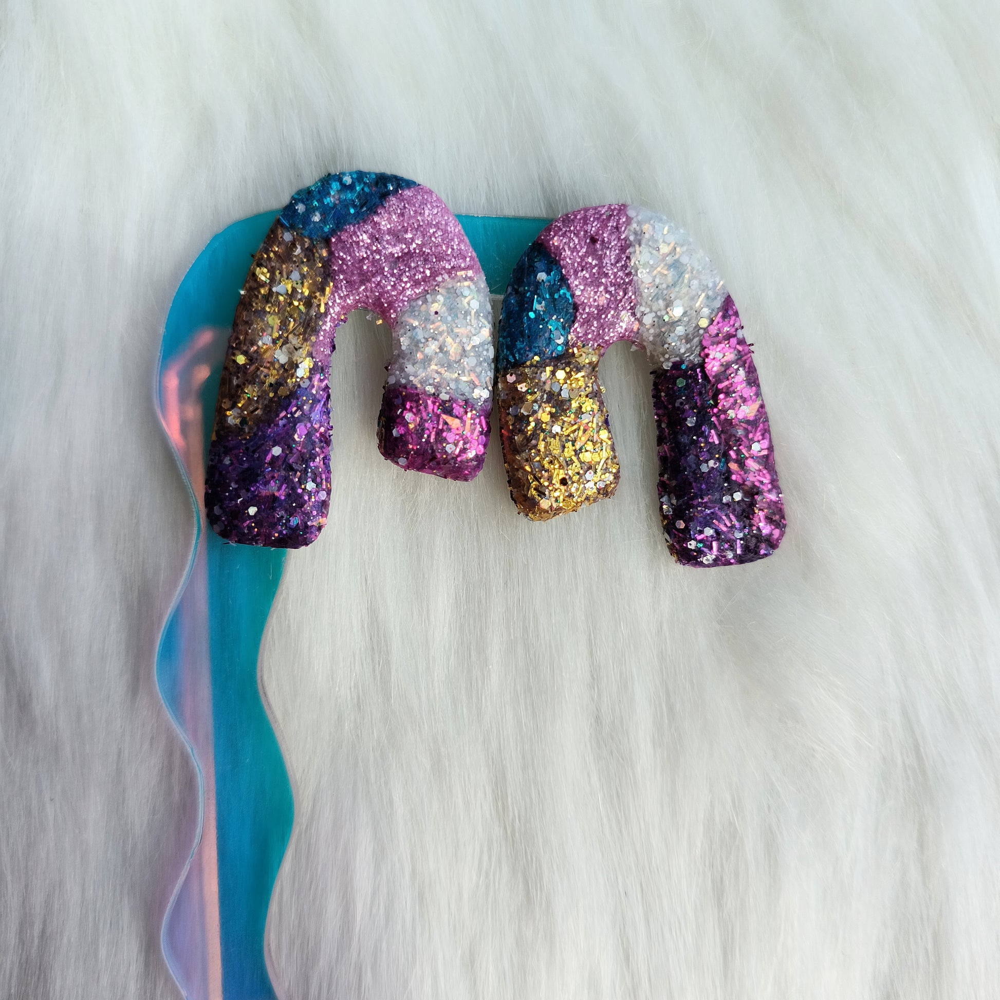 Multicolored glittery clay earrings on a white background